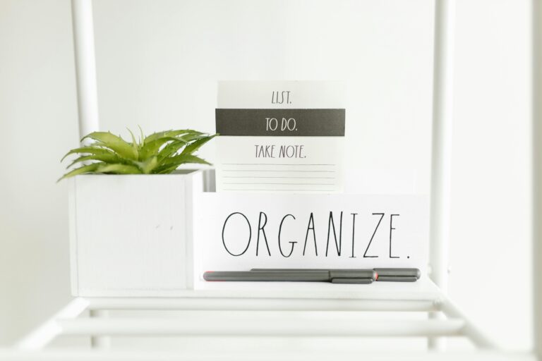A minimalist setup featuring a to-do list, plant, and pens for organized productivity.